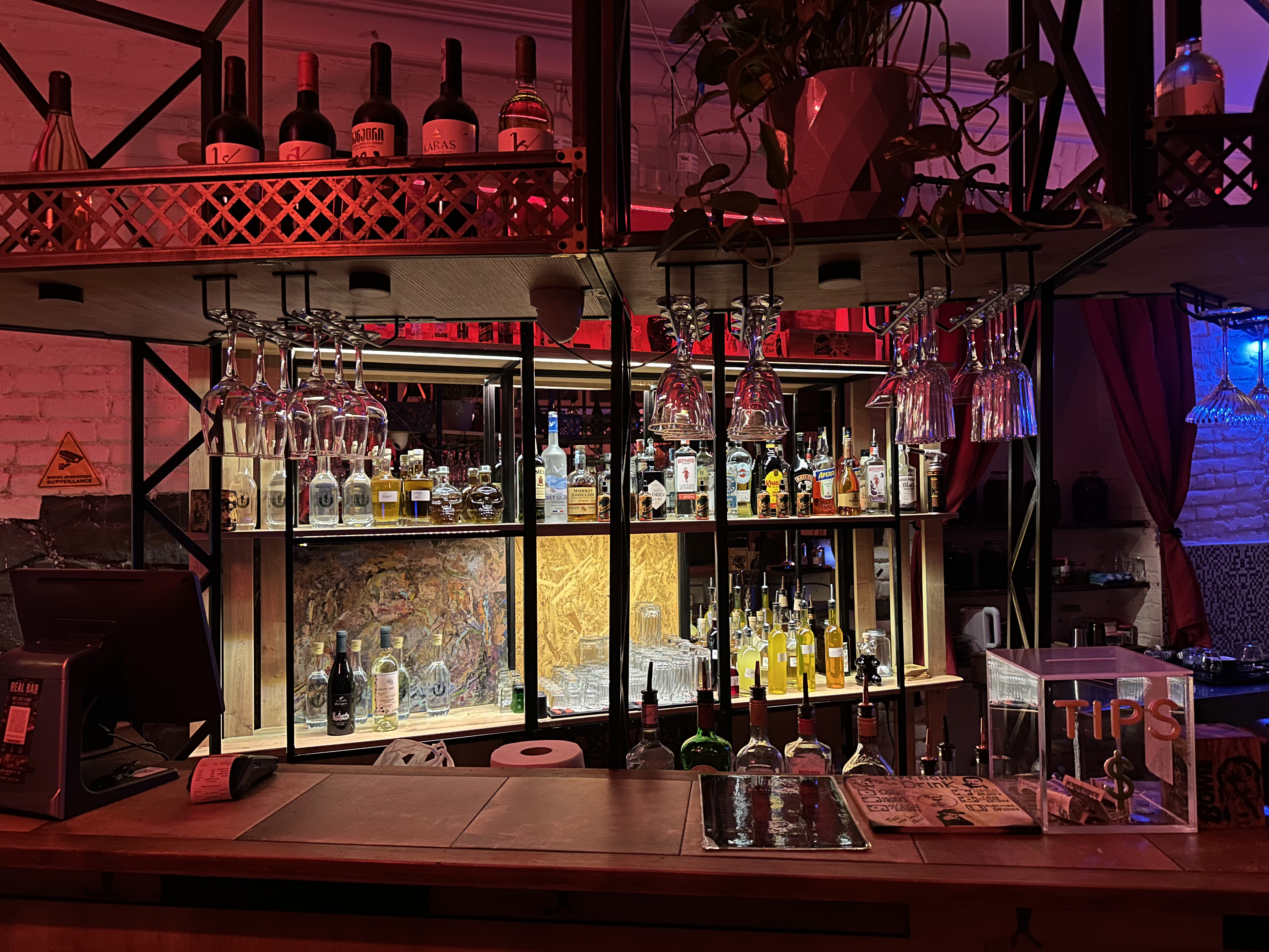 The bar at Real Bar lit with warm red light